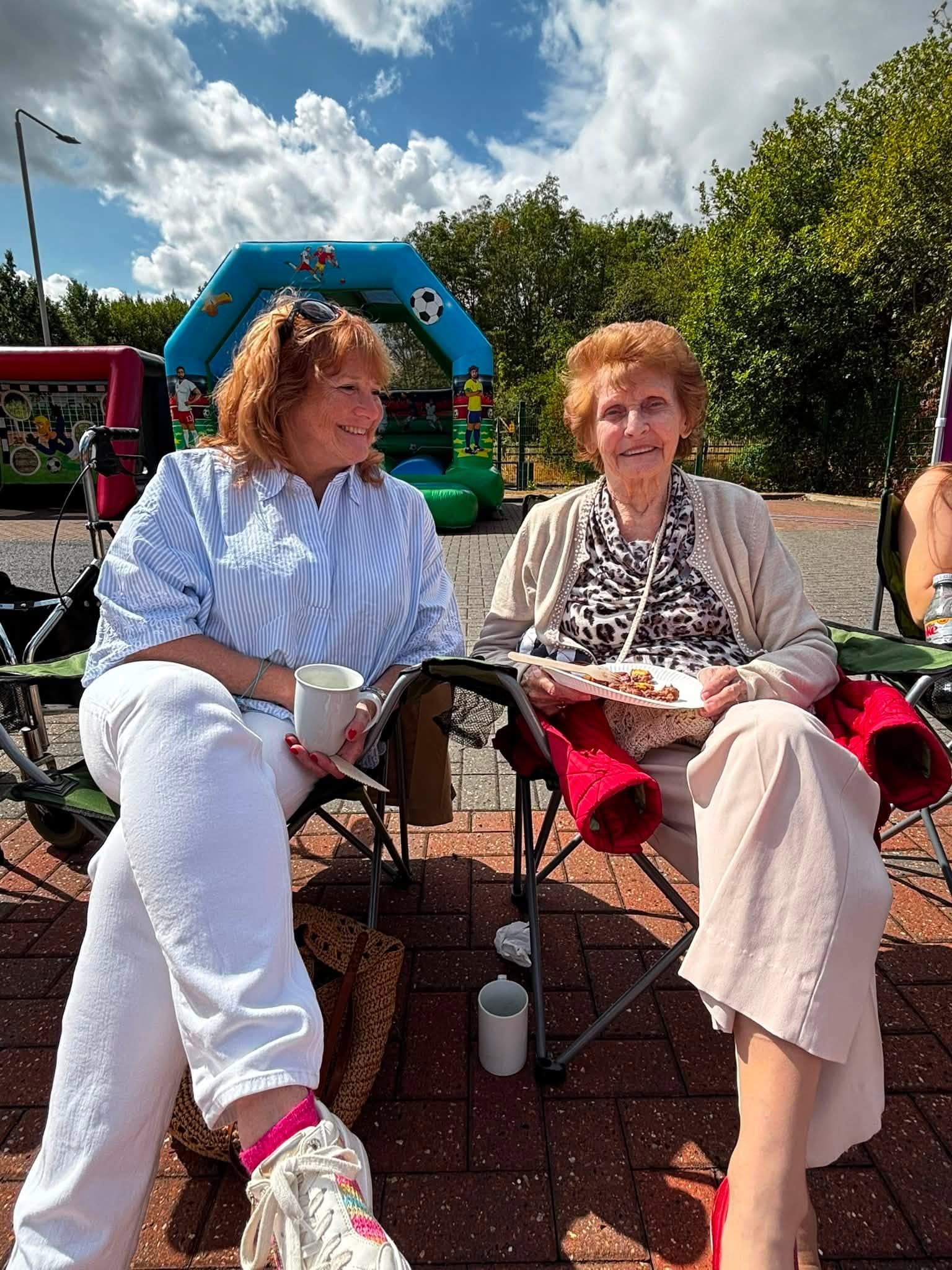 Two guests enjoying lunch together at the annual BBQ