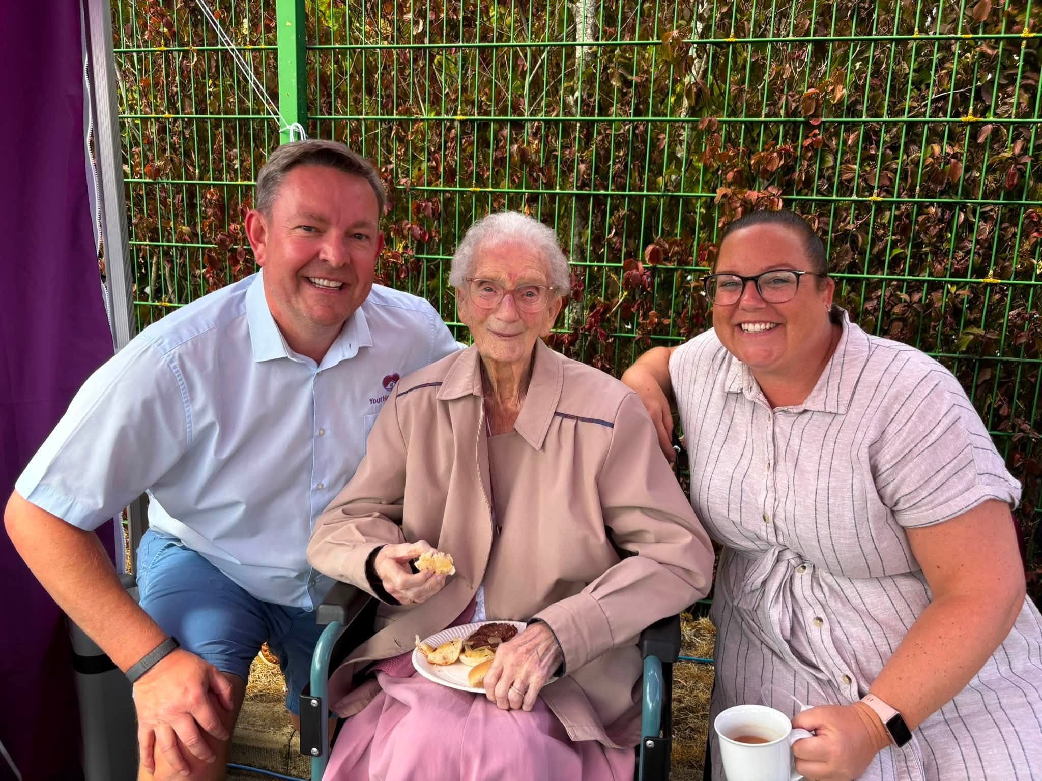 A client with two members of the Your Home Care team at the annual BBQ