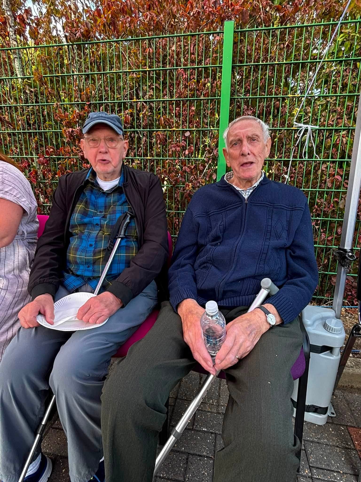 Two clients seated together at the annual BBQ