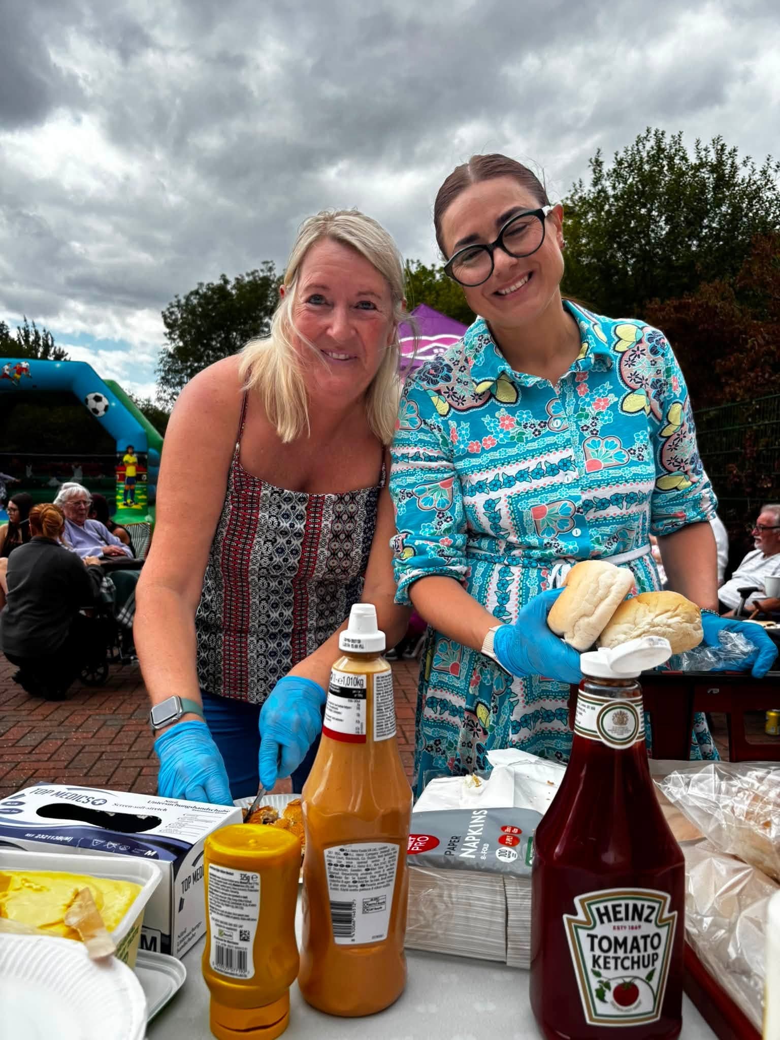 Your Home Care team members serving burgers at the annual BBQ