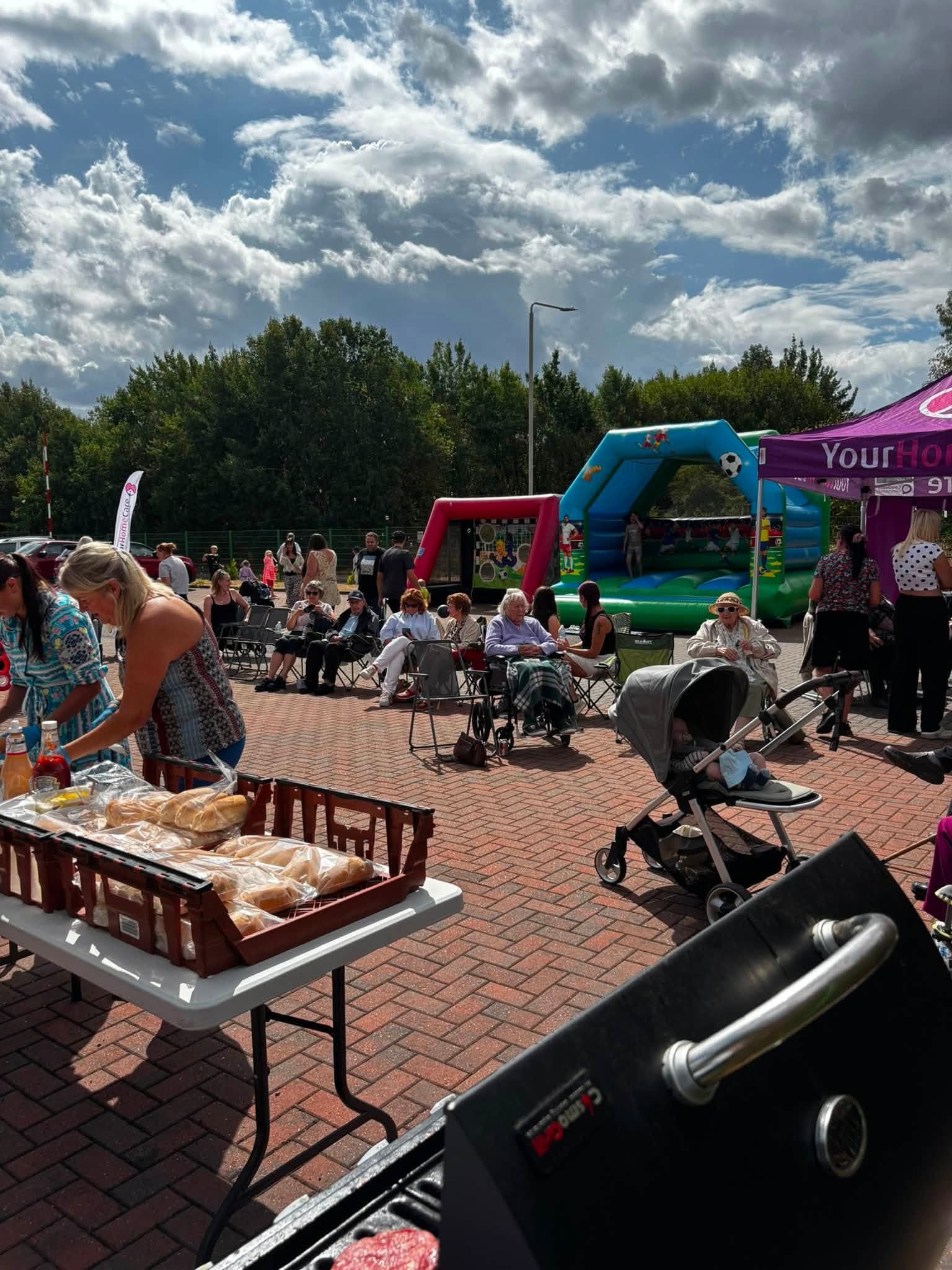 Guests gathered around the barbecue food table at the end of the celebration