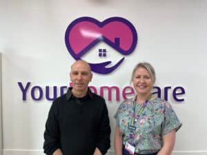 Registered Care Manager, Denise, with John B Tannen from Mansfield Radio 103.2, in front of our Your Home Care logo.