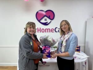 Harriett presenting Steph with a bouquet of flowers